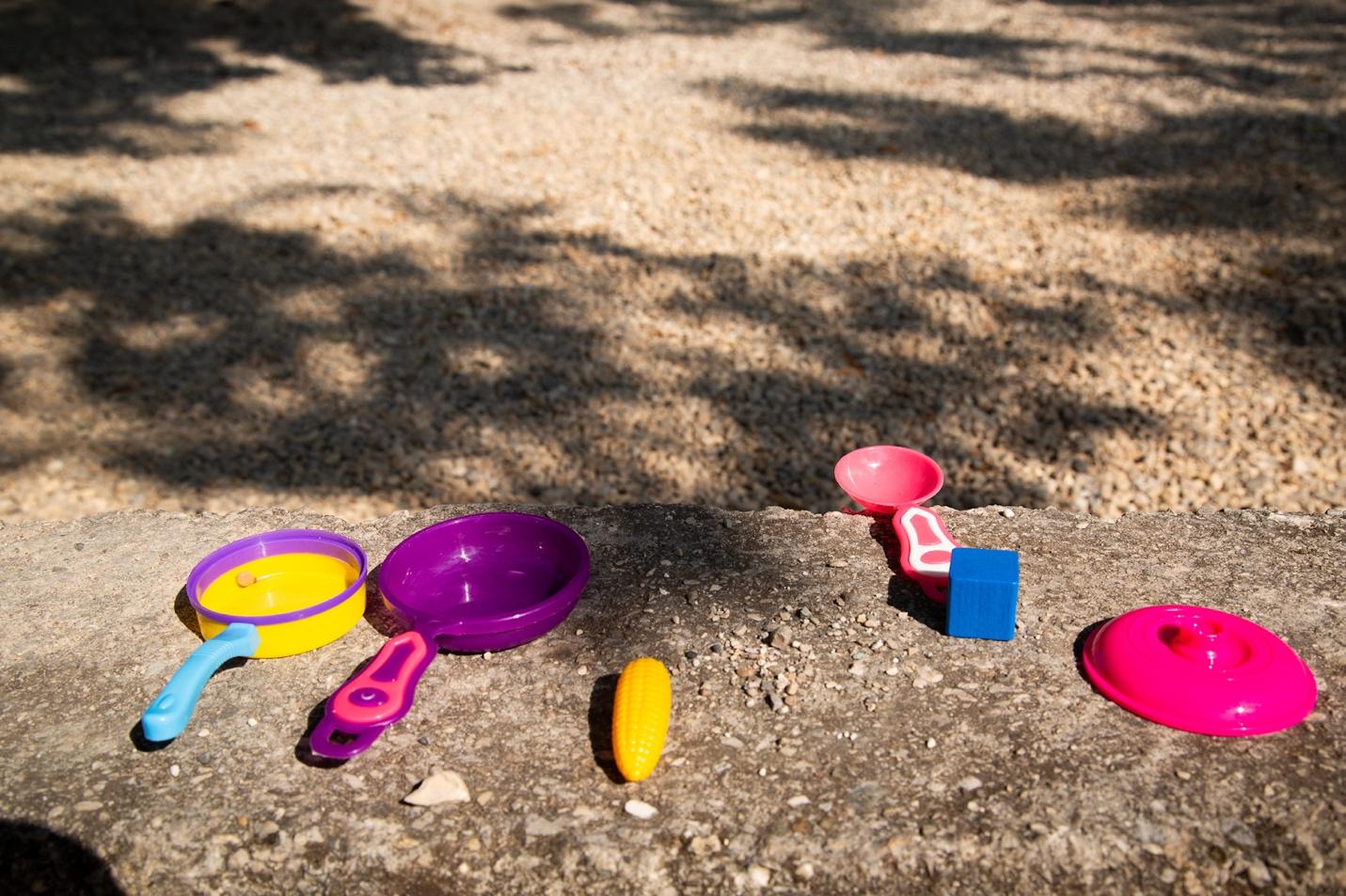 A group of toys on a rock

Description automatically generated