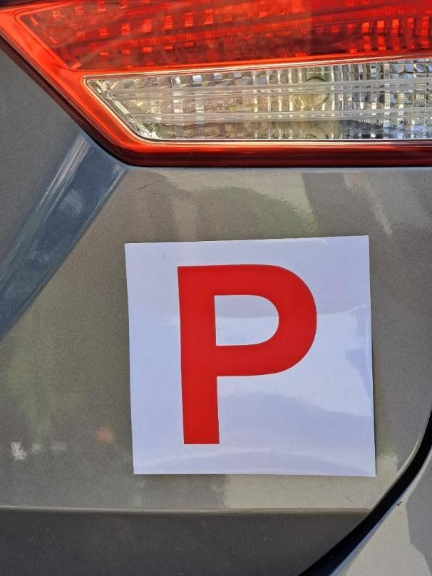 A sticker on a car

Description automatically generated