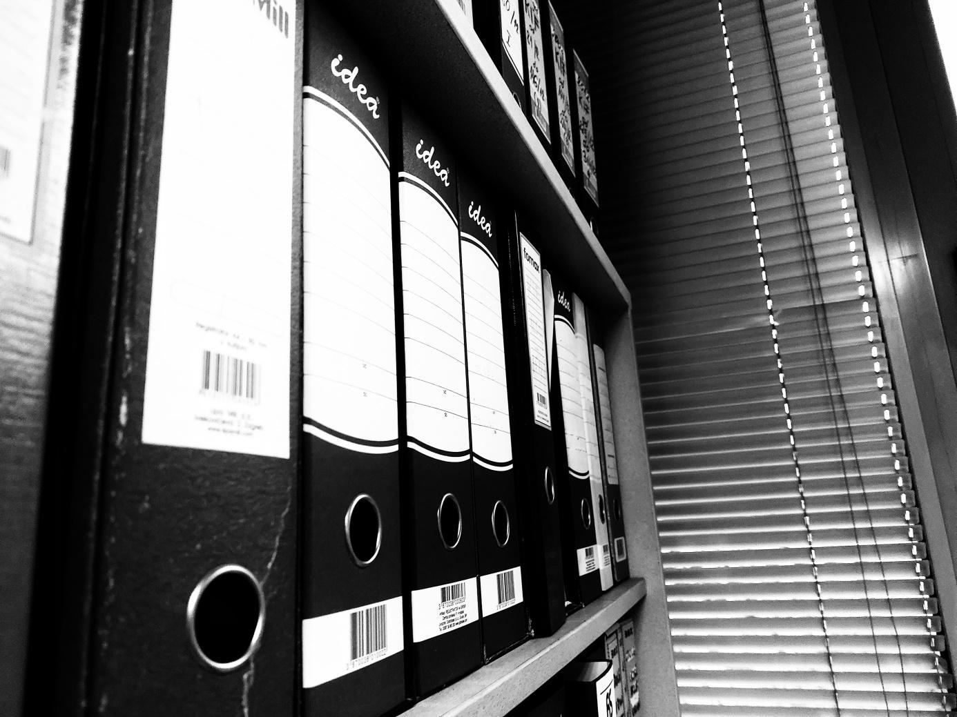 A shelf with binders on it

Description automatically generated